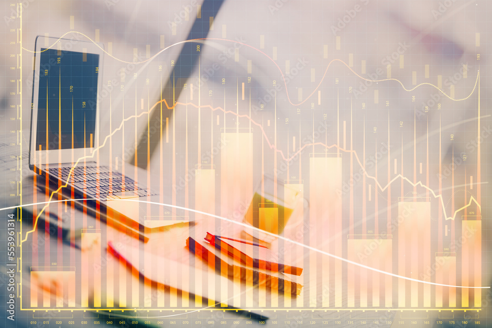 Forex Chart hologram on table with computer background. Double exposure. Concept of financial markets. Forex Chart hologram on table with computer background. Double exposure. Concept of financial markets.