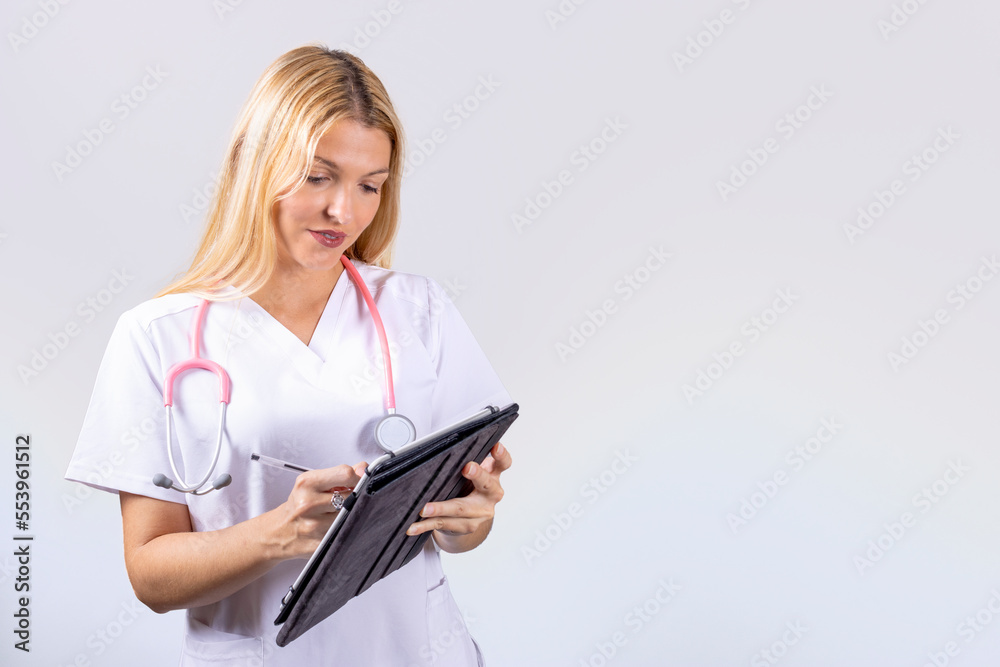 Young nurse with stethoscope writing notes Young nurse with stethoscope writing notes