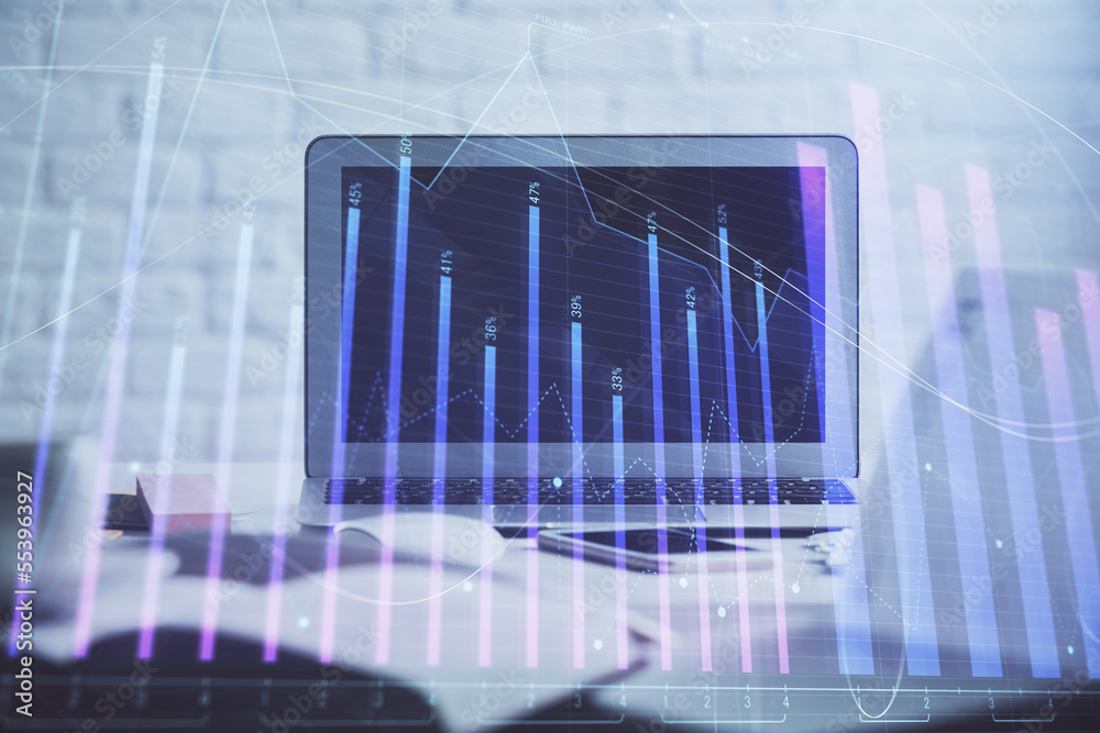Forex Chart hologram on table with computer background. Double exposure. Concept of financial markets. Forex Chart hologram on table with computer background. Double exposure. Concept of financial markets.