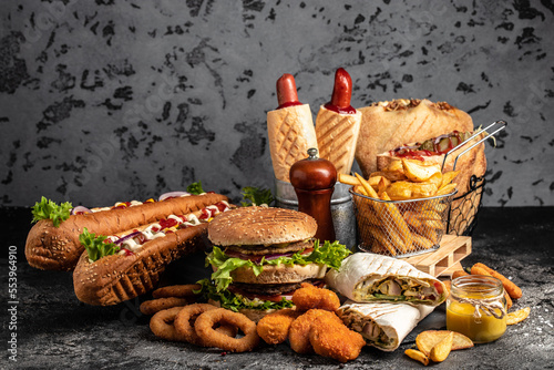 take away fast food products Kebab, pita, gyros, shaurma, wrap sandwich with french fries and nuggets meal, junk food and unhealthy food. banner, menu, recipe place for text