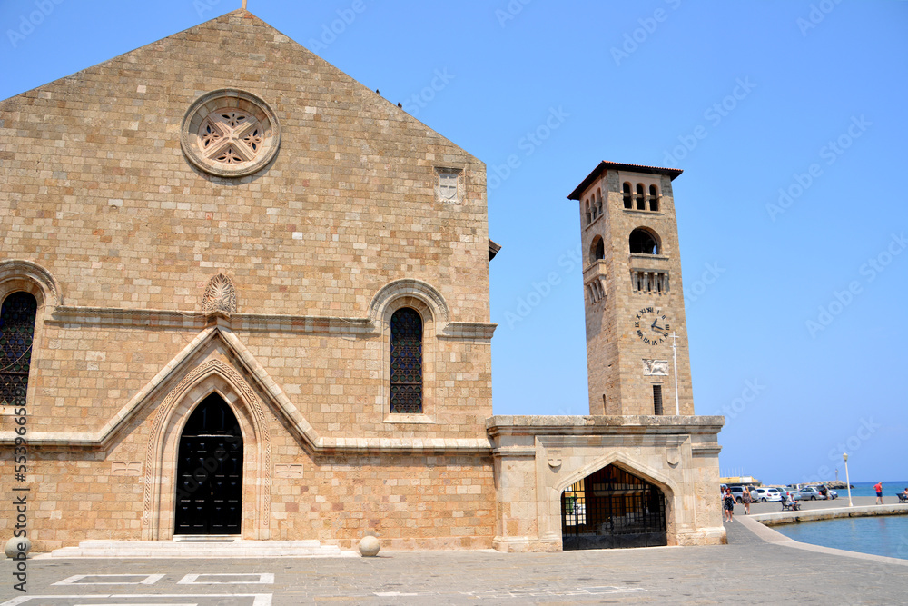 ancient monastery with clock tower in the port of greek island Rhodes isolated no people