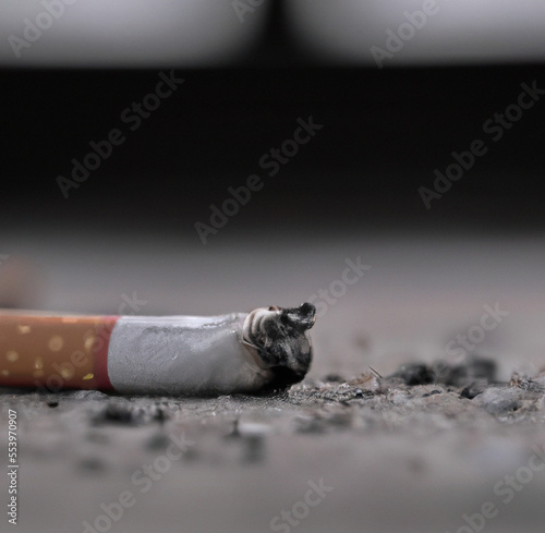 Close up of cigarette on ground with copy space created using Generative AI technology