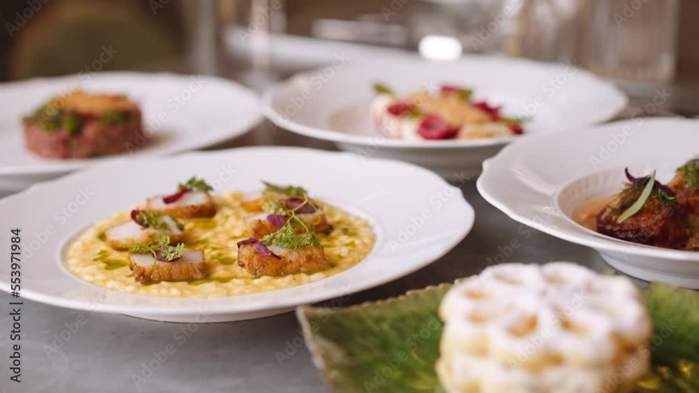 Scallop dish on table with other fancy dishes, tight Scallop dish on table with other fancy dishes, tight