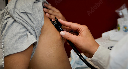 Photography Doctor auscultating with the stethoscope the chest of a child