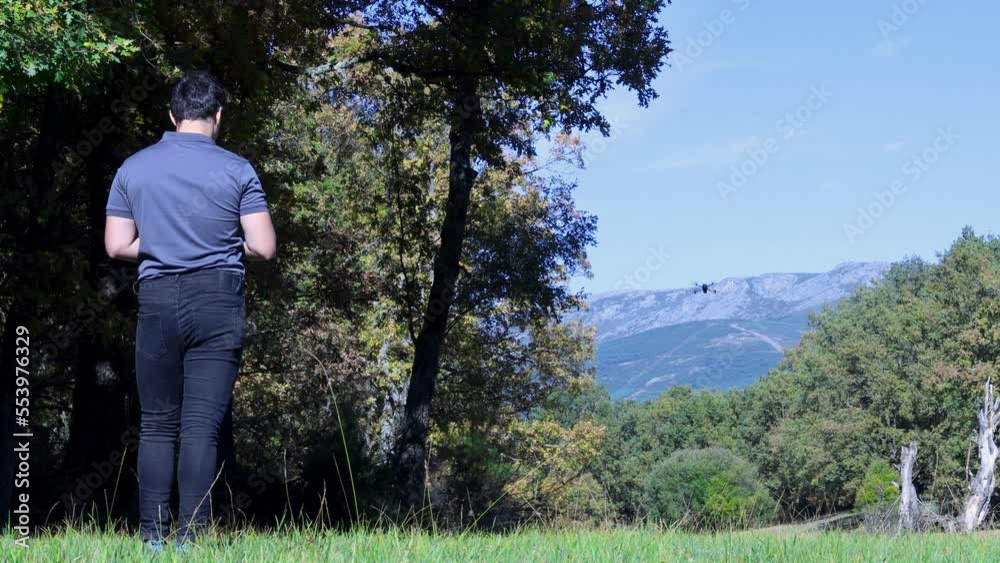Professional drone operator flying his drone in the nature. Professional drone operator flying his drone in the nature.
