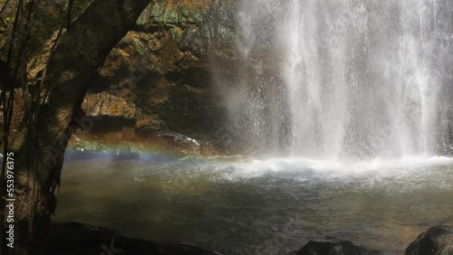 Amazing Wild Rainforest Jungle Waterfall with Rainbow in Water Stream Flow High Quality 4K Slowmotion Cinematic Footage. Thailand. photo