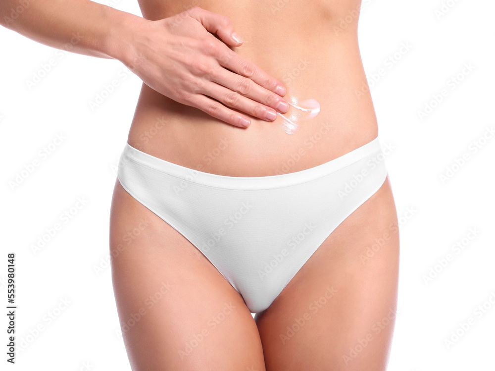 Woman applying body cream onto her belly against white background, closeup