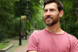 Portrait of handsome bearded man in park, space for text