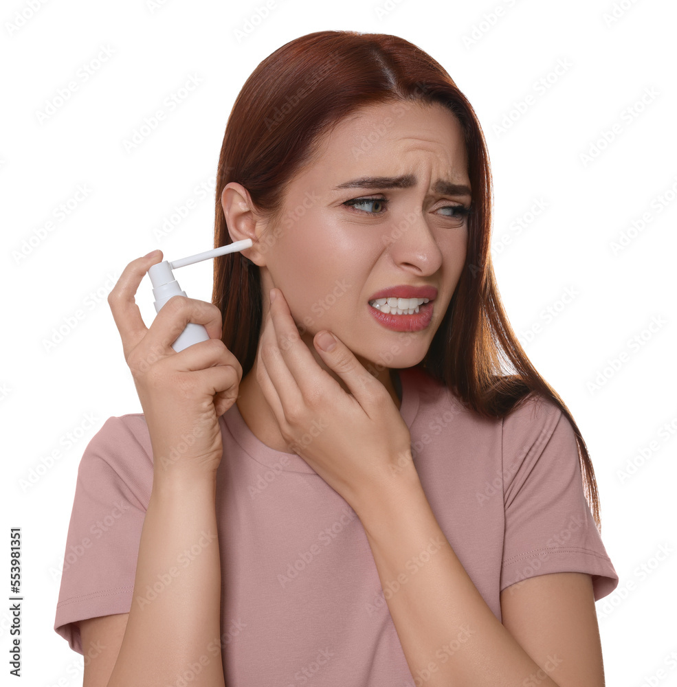Unhappy woman using ear spray on white background