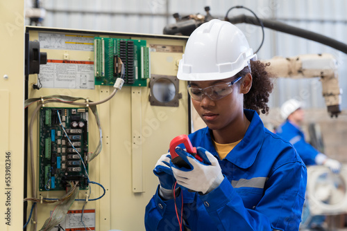 Fotografie Female electrician worker checking, repair, maintenance operation electric system in the factory