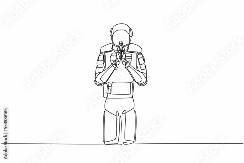 Single one line drawing young astronaut standing with holding palms in prayer. Spaceman emotion, body language gesture. Cosmic galaxy space concept. Continuous line graphic design vector illustration