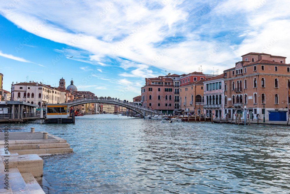 The characteristic architecture and colors of Venice. View of the Grand Canal and glimpse of the Scalzi bridge.