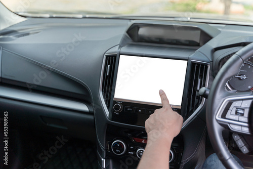 Monitor in car with isolated blank screen use for navigation maps and GPS. Isolated on white with clipping path. Car detailing. Finger touching blank screen.