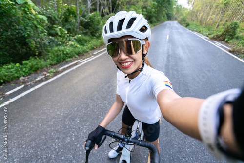 happy woman cycling athlete prepare for ride bicycle on street, road, with high speed for exercise hobby and competition in professional tour