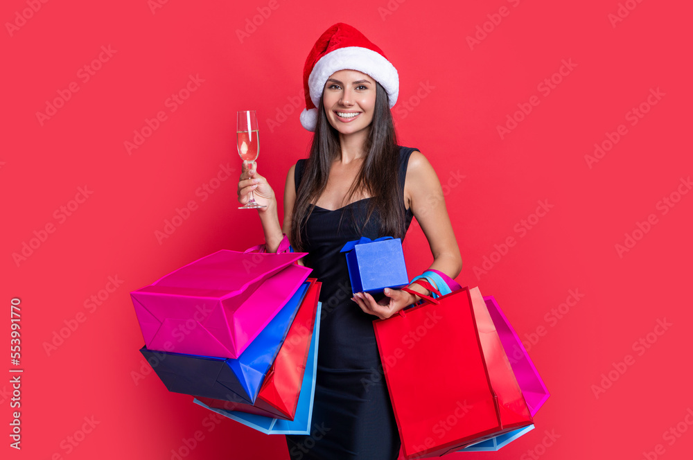 cheerful new year shopaholic woman isolated on red. new year shopping bags and shopaholic woman. cheerful new year shopaholic woman isolated on red. new year shopping bags and shopaholic woman.