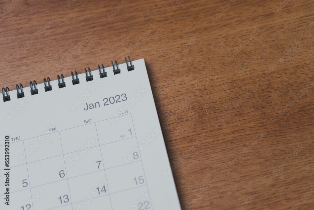 January 2023 calendar page on wood background. Calendar background for reminder, business planning, appointment meeting and event. January 2023 calendar page on wood background. Calendar background for reminder, business planning, appointment meeting and event.