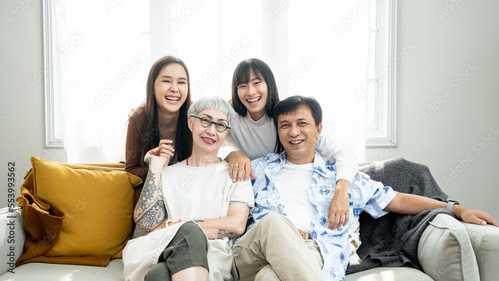 Happiness Asian family candid of daughter hugging the grandparent mother father senior elder cozy relax on sofa couch surprise visiting in living room at home, together hug cheerful Asian family home. Happiness Asian family candid of daughter hugging the grandparent mother father senior elder cozy relax on sofa couch surprise visiting in living room at home, together hug cheerful Asian family home.