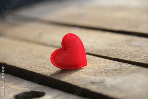 Red heart on a wooden background. Place for text. Valentine.