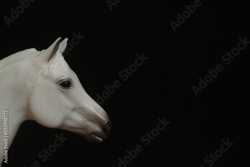 Black toy horse isolated on black background © Mk16.15