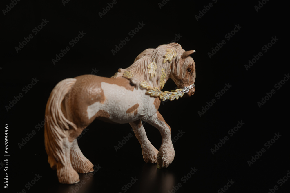 Fototapeta premium Black toy horse isolated on black background
