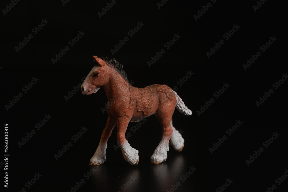 Black toy horse isolated on black background Black toy horse isolated on black background