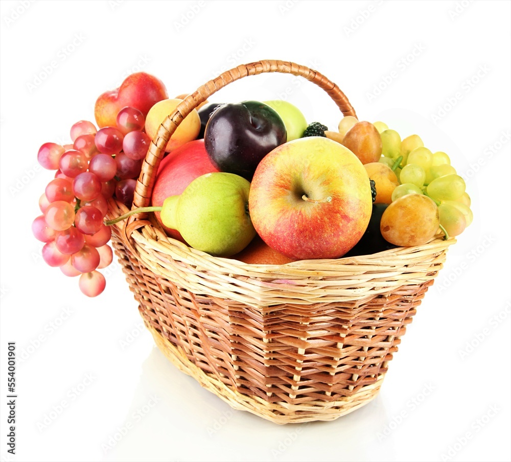 Mixed fruit in a wicker basket on a white background Mixed fruit in a wicker basket on a white background