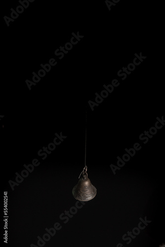 Solid brass or bronze vintage bell on black background © Mk16.15