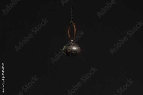 Solid brass or bronze vintage bell on black background