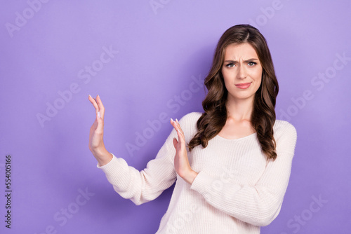 Photo of stressed depressed gloomy frowning arm empty space showing disagreement negative choice isolated on purple color background