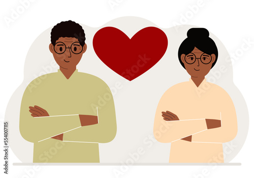 Happy man and woman next to a big red heart. Love.
