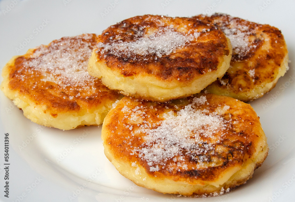 Syrniki (cottage cheese pancakes or curd fritters) in a white ceramic bowl, Healthy food. Food close-up.