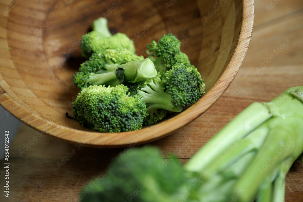 fresh broccoli in a wooden basket bowl fresh broccoli in a wooden basket bowl