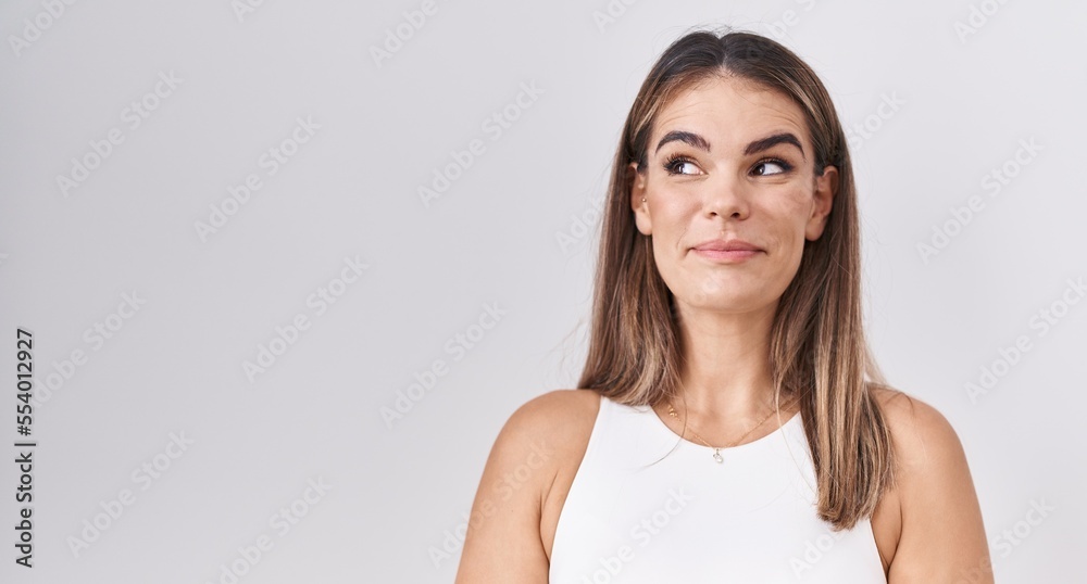 Hispanic young woman standing over white background smiling looking to the side and staring away thinking. Hispanic young woman standing over white background smiling looking to the side and staring away thinking.