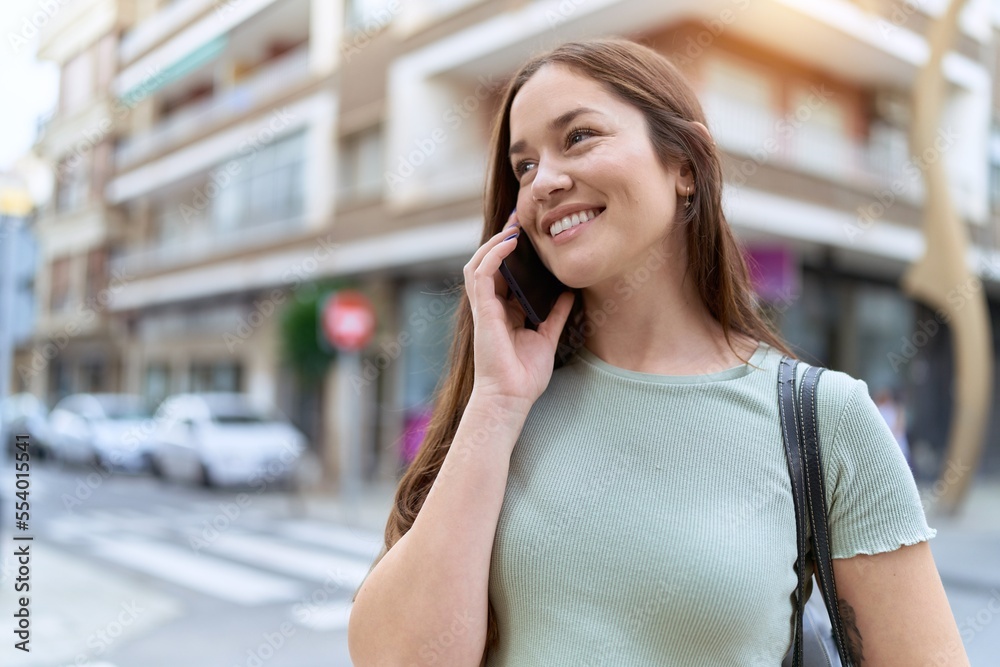 Young beautiful woman smiling confident talking on the smartphone at street Young beautiful woman smiling confident talking on the smartphone at street