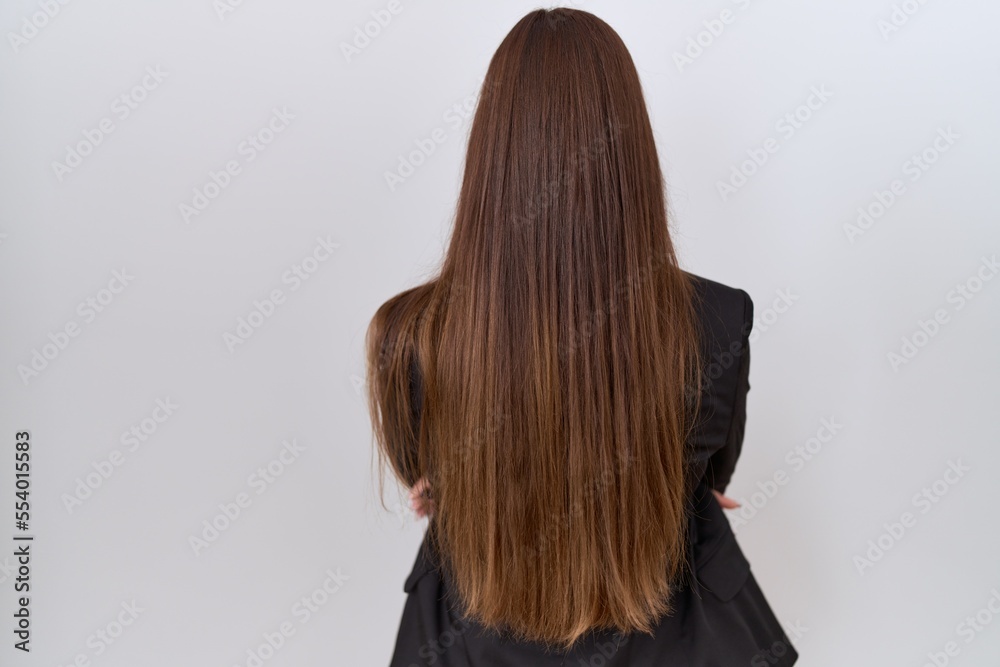 Naklejka premium Beautiful brunette woman wearing business jacket and glasses standing backwards looking away with crossed arms