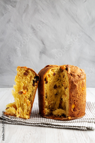 Homemade Italian Panettone with Raisins and Large Pieces of Candied Fruit, side view. Close-up.