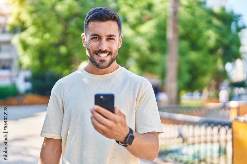 Young hispanic man smiling confident using smartphone at park Young hispanic man smiling confident using smartphone at park