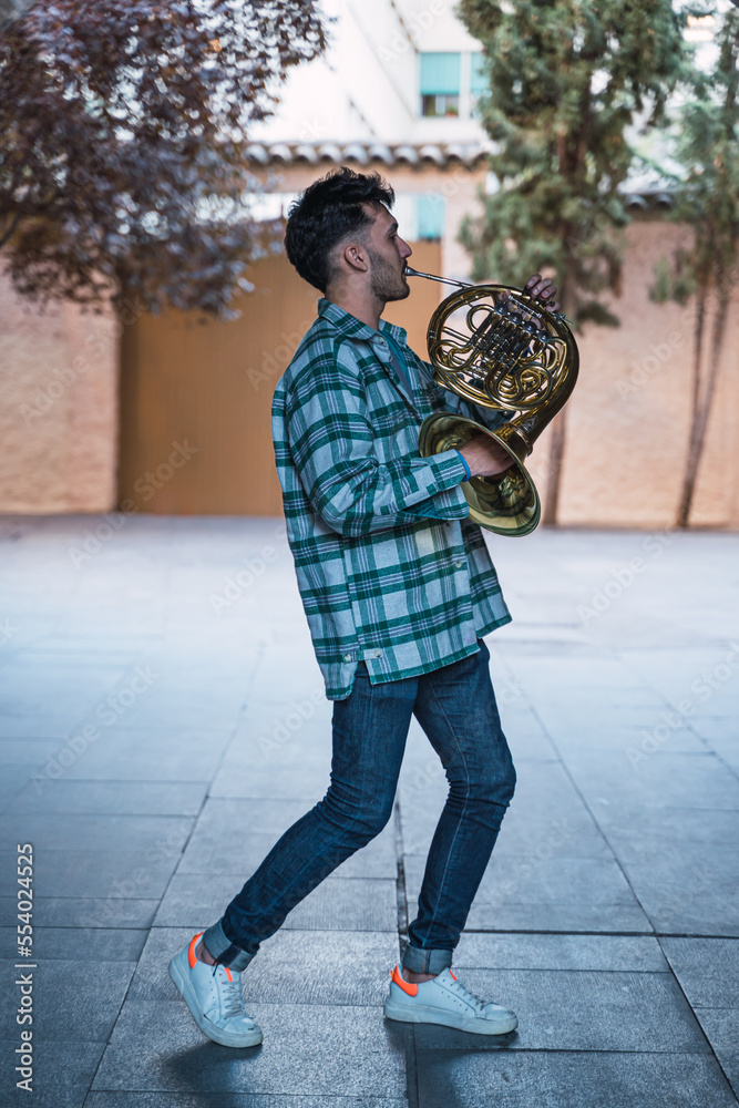 Young man playing the horn in a tunes of zaragoza spain