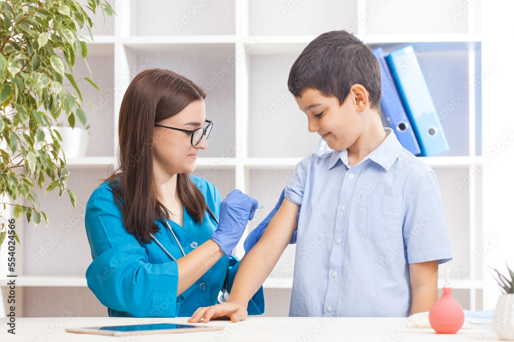 vaccination of children, a little boy at a doctor's appointment, an injection in the arm vaccination of children, a little boy at a doctor's appointment, an injection in the arm