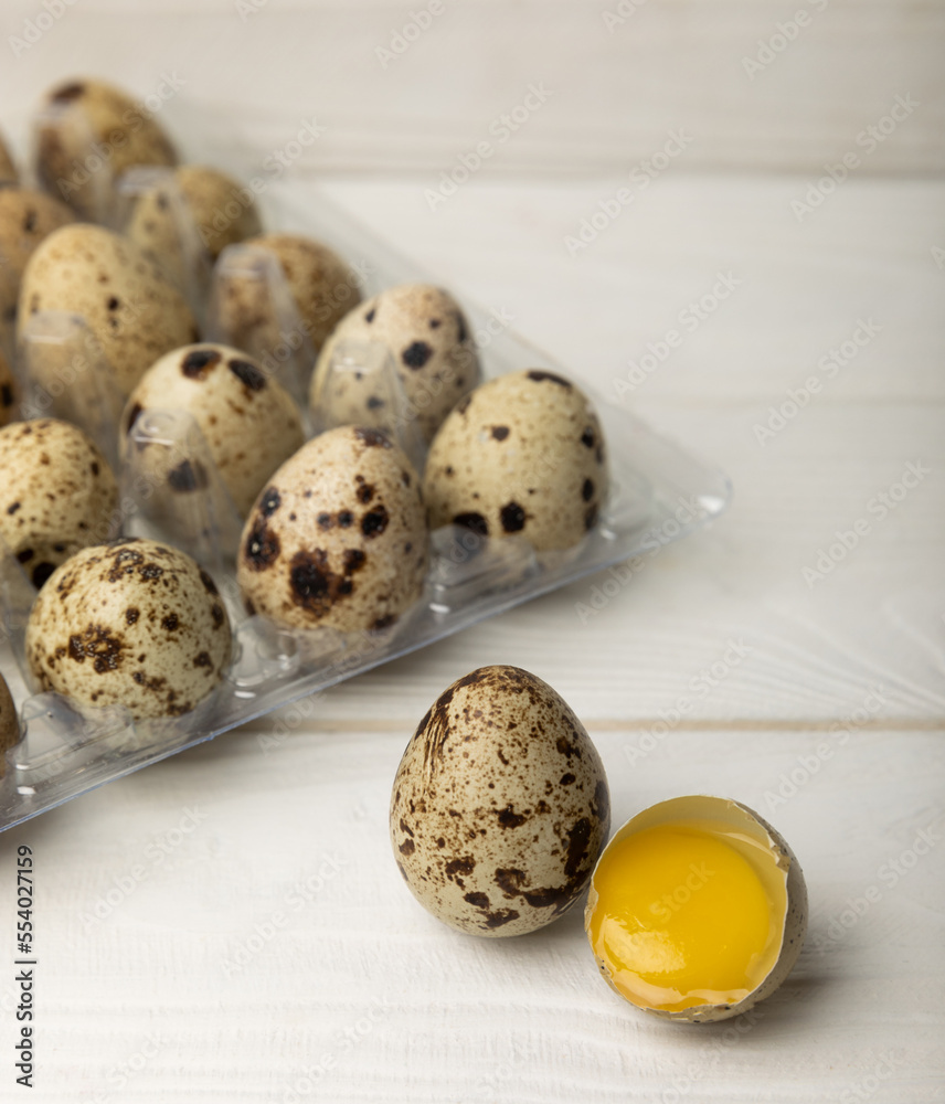 Quail eggs in a plastic package on a white wooden background. Healthy food. Diet. top view. free space.