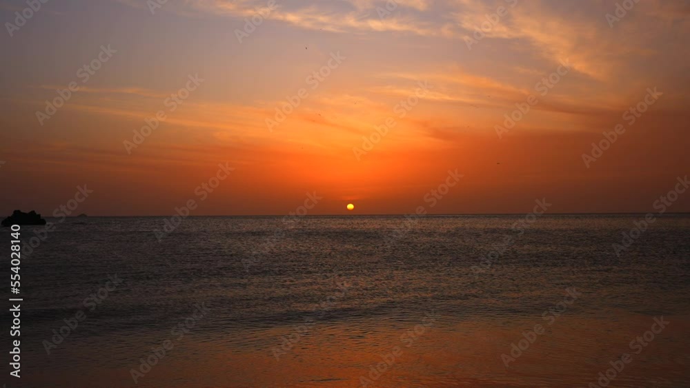 Amazing pink sunset on the beach. The last sun over the horizon. Beautiful orange sky Amazing pink sunset on the beach. The last sun over the horizon. Beautiful orange sky