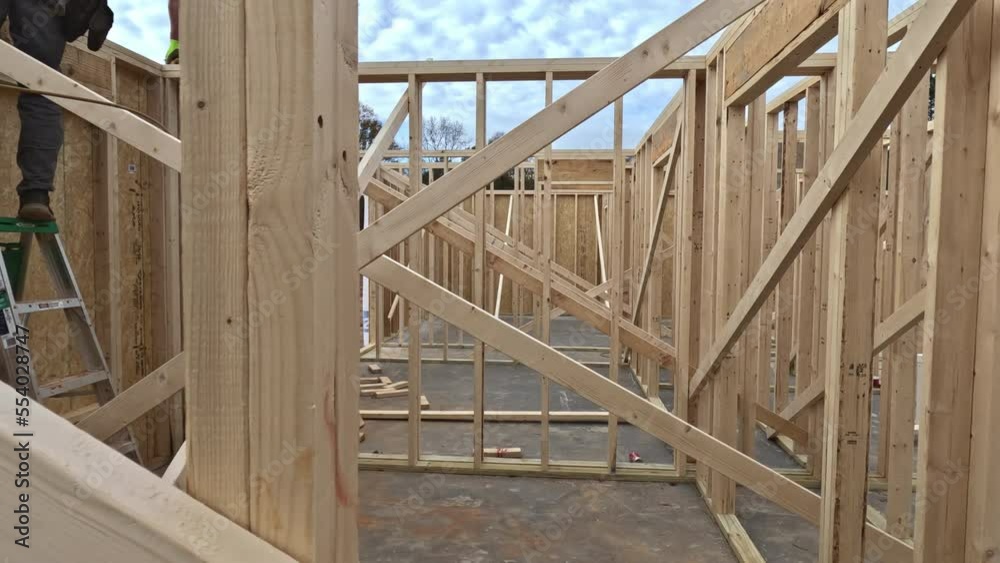 Closeup new stick built home under construction under framing structure wood frame building construction of panorama view Closeup new stick built home under construction under framing structure wood frame building construction of panorama view