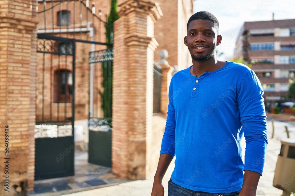Fototapeta premium Young african american man smiling confident standing at street