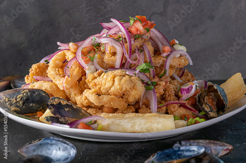 Jalea Mixta - fried seafood dish from Peru with squid, mussells and fish.