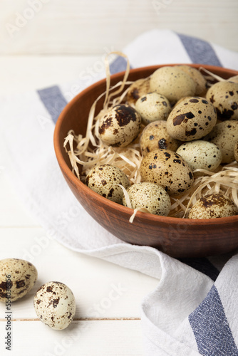Quail eggs in a plate on a white wooden background. Healthy food. Diet. top view. free space.