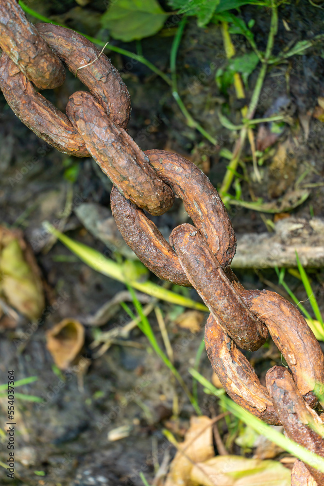 An old rusty anchor chain. Fixing the boat on the pier. Rusty iron construction. An old rusty anchor chain. Fixing the boat on the pier. Rusty iron construction.