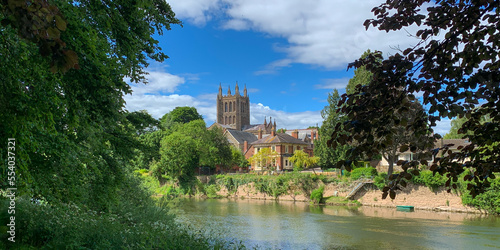 Looking across the River Wye to Hereford Cathedral on a beautiful spring day in Hereford, Herefordshire, UK. A mobile phone photo with some phone or tablet post processing. photo