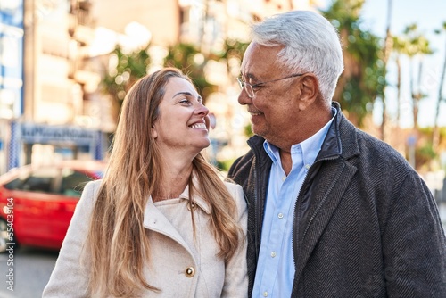 Middle age man and woman couple smiling confident standing together at street © Krakenimages.com