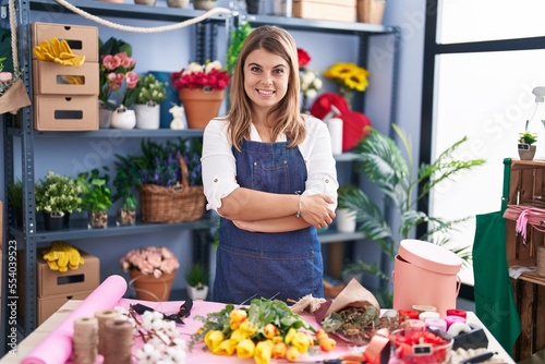 Young woman florist smiling confident standing with arms crossed gesture at florist