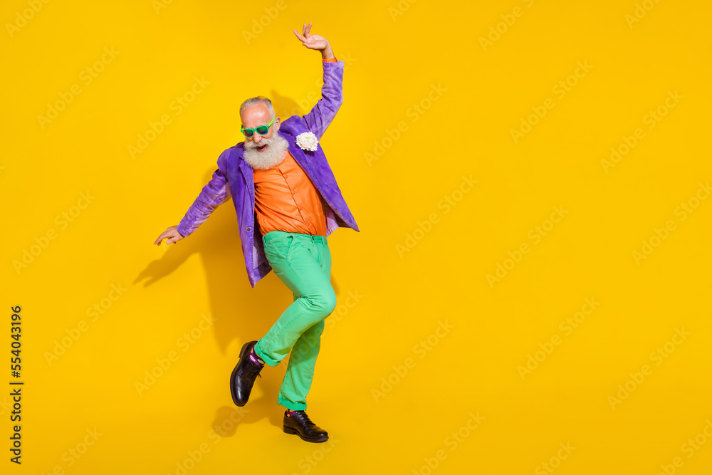 Full length photo of attractive excited man wear purple velvet jacket enjoying discotheque empty space isolated yellow color background